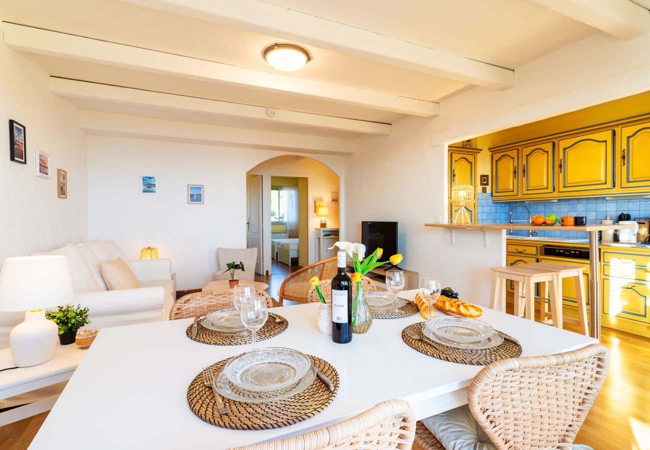 Bright living room with dining area and an open Mediterranean-style kitchen